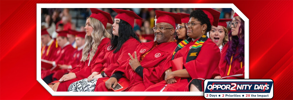 Photo of diverse amount of students sitting at commencement ceremony in gowns where some are posing for the camera and the Oppor2nity Days logo is nestled in the righ-hand corner of the picture